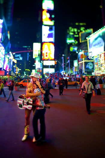 The Naked Cowboy shares a quite moment with a fan in Times Square.