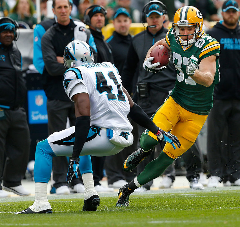 Green Bay Packers wide receiver Jordy Nelson gets past Carolina Panthers strong safety Roman Harper on his way to a 59 years catch and run touchdown.