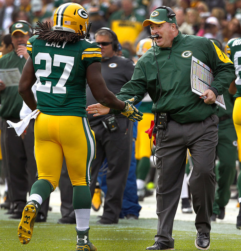 Green Bay Packers head coach Mike McCarthy congratulates Green Bay Packers running back Eddie Lacy on a touchdown run.