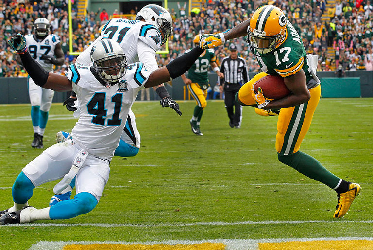 Green Bay Packers wide receiver Davante Adams gets in to the end zone for a touchdown as Carolina Panthers strong safety Roman Harper tries to defend.