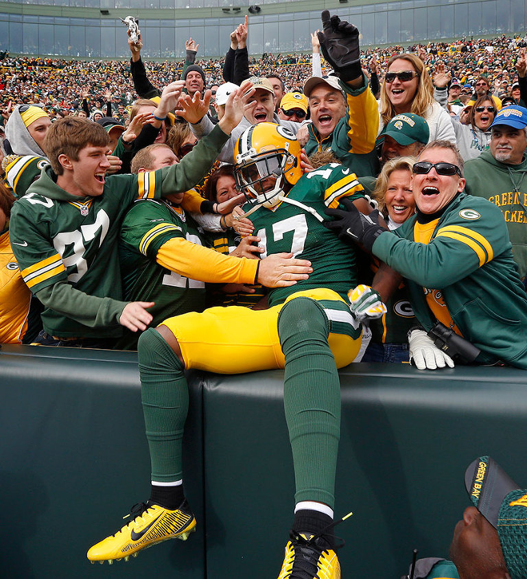 Green Bay Packers wide receiver Davante Adams does a Lambeau Leap to celebrate his touchdown.