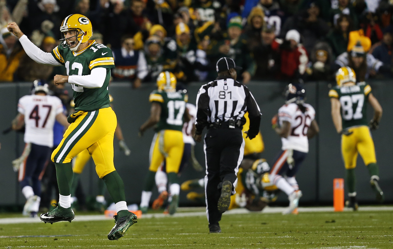 Green Bay Packers quarterback Aaron Rodgers celebrates a touchdown pass to wide receiver Randall Cobb.