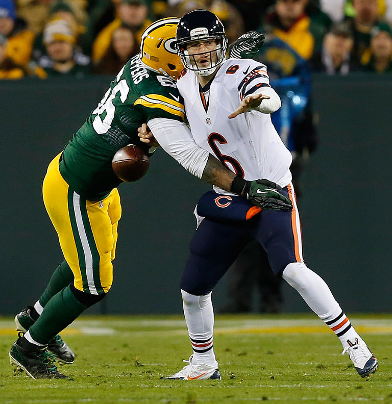 Green Bay Packers outside linebacker Julius Peppers knocks the ball out of Chicago Bears quarterback Jay Cutler hands.