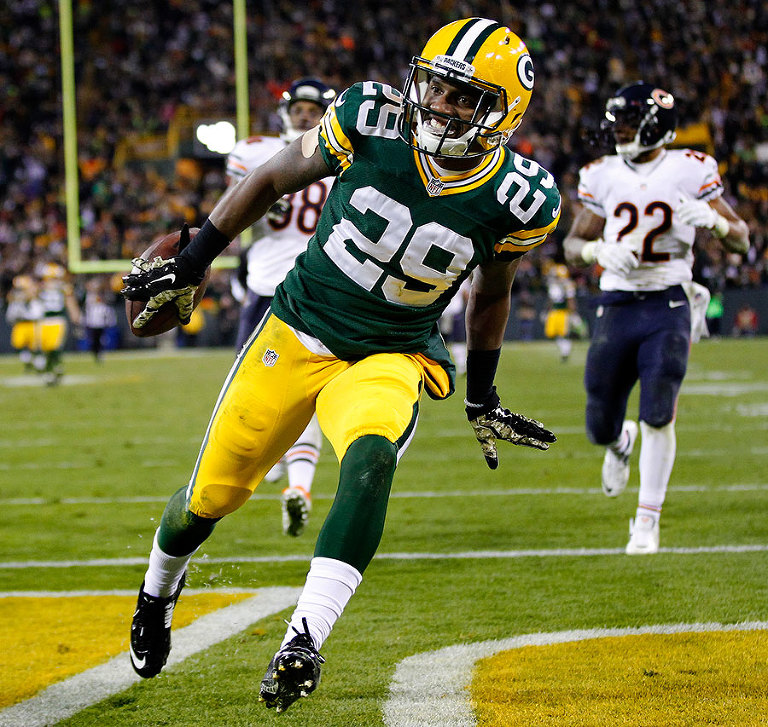 Green Bay Packers cornerback Casey Hayward smiles as he runs in to the end zone to score a touchdown on an interception return.