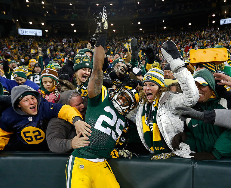 Green Bay Packers cornerback Casey Hayward does a Lambeau Leap to celebrate his touchdown.