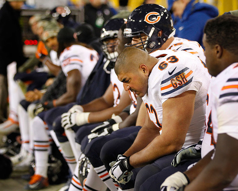 The Chicago Bears bench hangs their heads in the final minutes of their lopsided lose to the Green Bay Packers.
