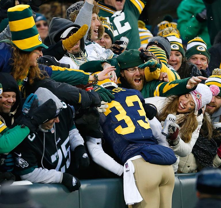 Green Bay Packers free safety Micah Hyde celebrates his punt return touchdown with a Lambeau Leap.