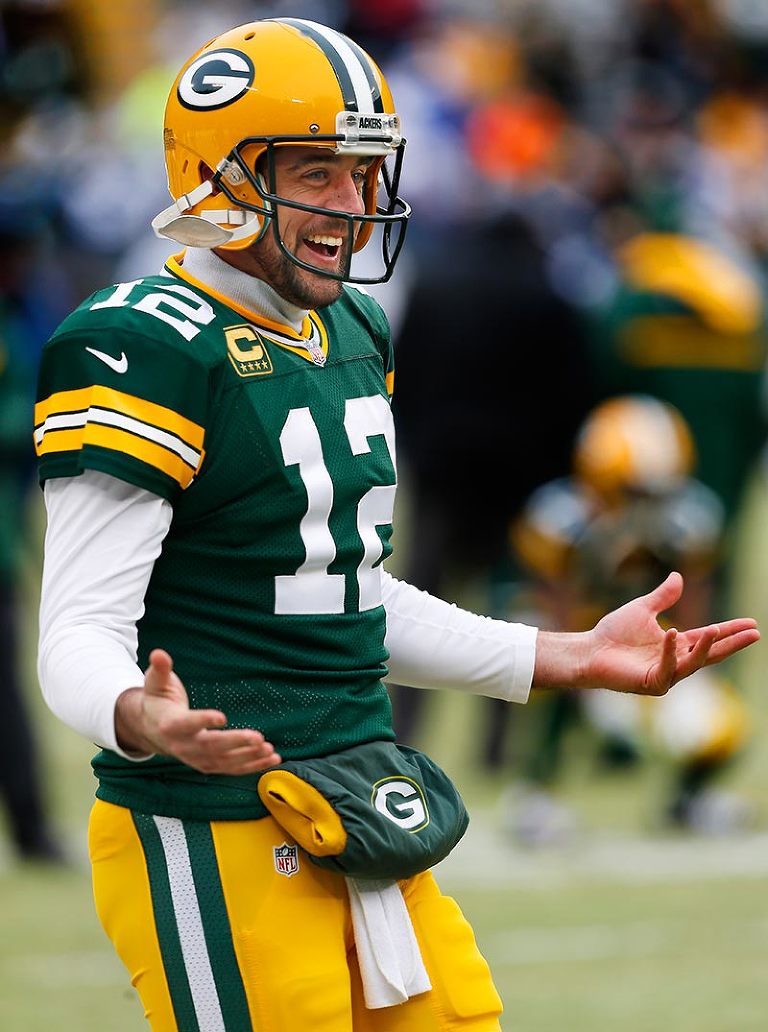 A happy Green Bay Packers' Aaron Rodgers warms up before the game.