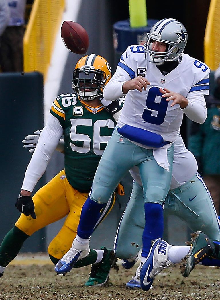 Green Bay Packers' Julius Peppers knocks the ball out of Dallas Cowboys' Tony Romo hand forcing a fumble.