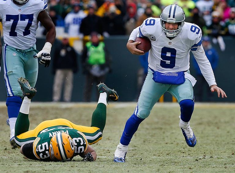 Dallas Cowboys' Tony Romo eludes the pressure of Green Bay Packers' Nick Perry.