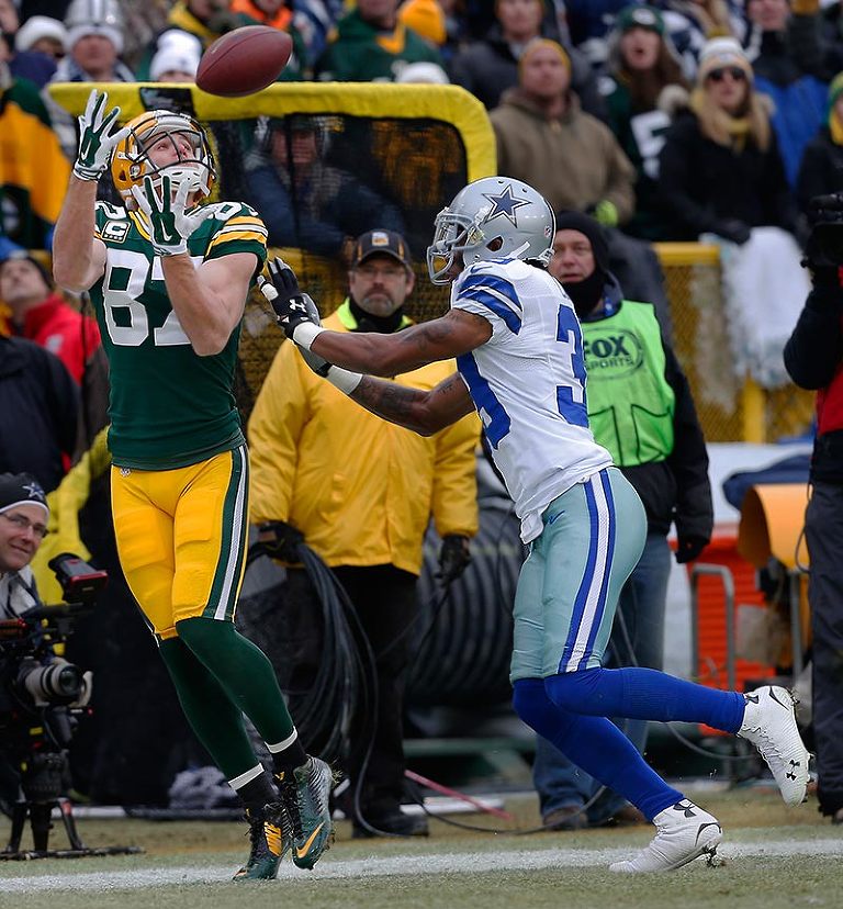Green Bay Packers wide receiver Jordy Nelson can't keep his feet inbounds as Dallas Cowboys cornerback Brandon Carr defends.