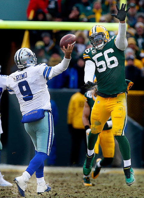Green Bay Packers outside linebacker Julius Peppers tries to block a Dallas Cowboys quarterback Tony Romo pass.