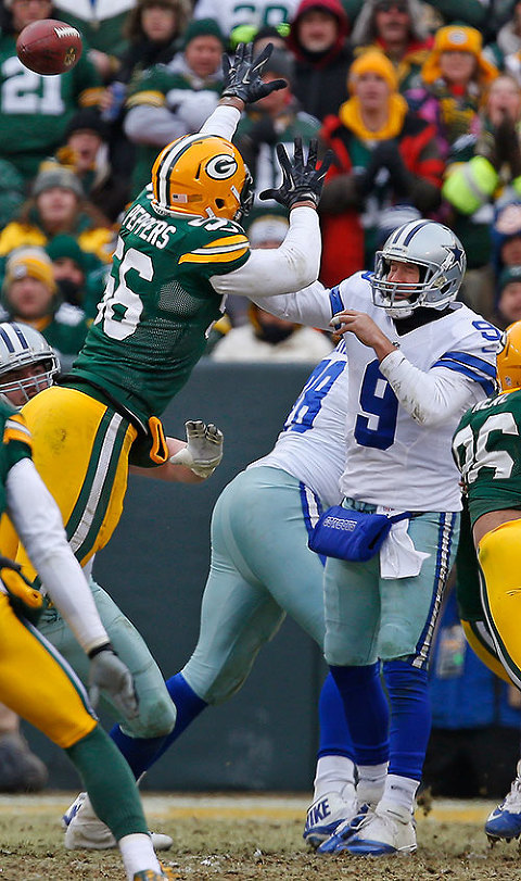 Green Bay Packers outside linebacker Julius Peppers pressures Dallas Cowboys quarterback Tony Romo.