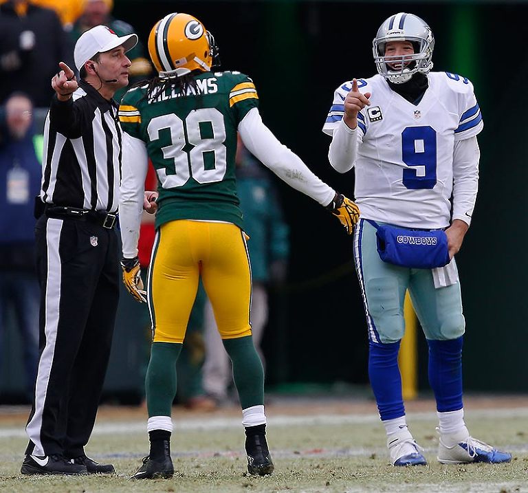 Green Bay Packers cornerback Tramon Williams and Dallas Cowboys quarterback Tony Romo ague their case on a penalty.  Williams won the debate.
