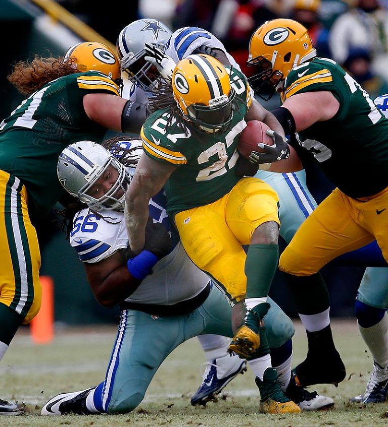 Dallas Cowboys defensive tackle Ken Bishop tries to stop Green Bay Packers running back Eddie Lacy.