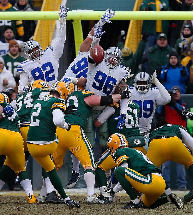 The Dallas Cowboys try to block a Green Bay Packers kicker Mason Crosby field goal.
