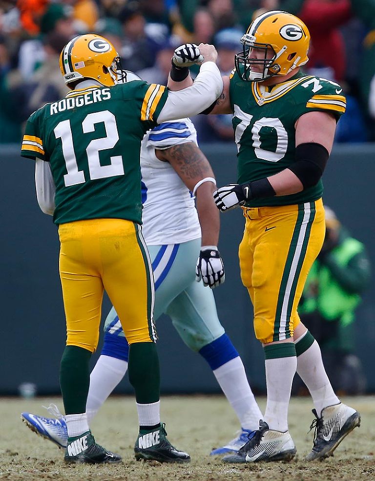 Green Bay Packers quarterback Aaron Rodgers and guard T.J. Lang celebrate a touchdown.