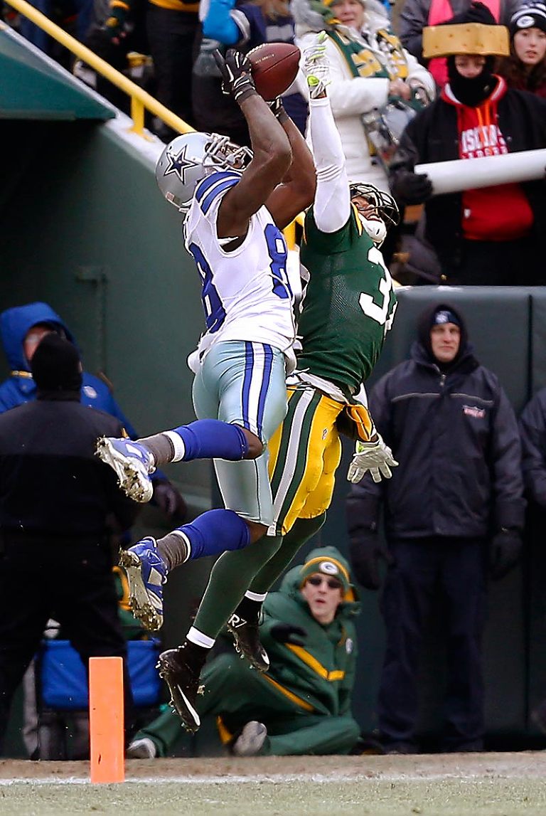 Green Bay Packers cornerback Sam Shields defends a pass on fourth down intended for Dallas Cowboys wide receiver Dez Bryant.  After the Packers threw a red flag challenging that the catch wasn't good the call was reversed and the Packers took over possession of the ball.