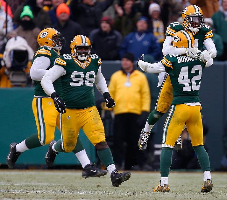 The Packers defense celebrates winning the challenge on Dallas Cowboys wide receiver Dez Bryant catch not being good and taking over possession on downs.