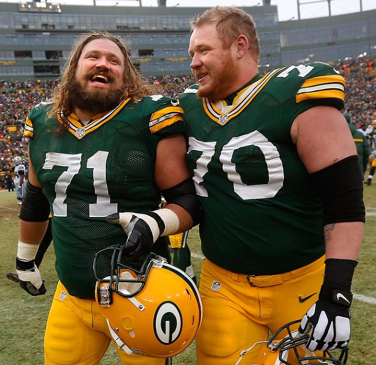 Green Bay Packers guard Josh Sitton and Green Bay Packers' T.J. Lang are all smiles as they walk of the field after defeating the Cowboys.