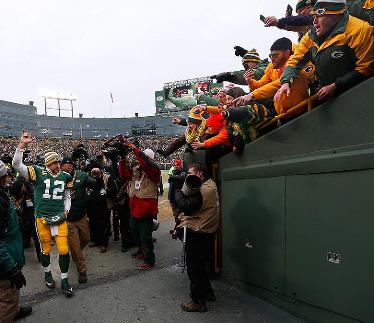 Green Bay Packers quarterback Aaron Rodgers hangs loose as he walks off the field after the Packers defeated the Cowboys.