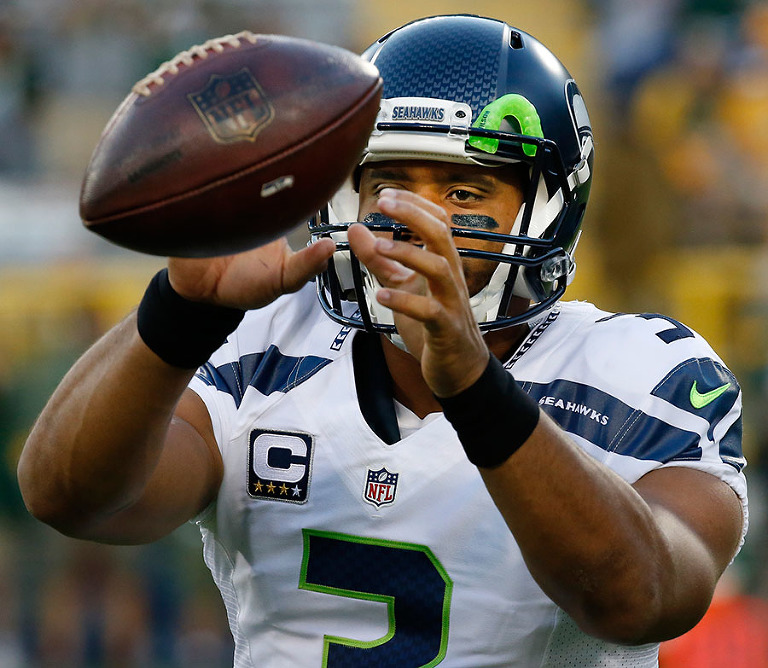 Seattle Seahawks' Russell Wilson warms up before the game.