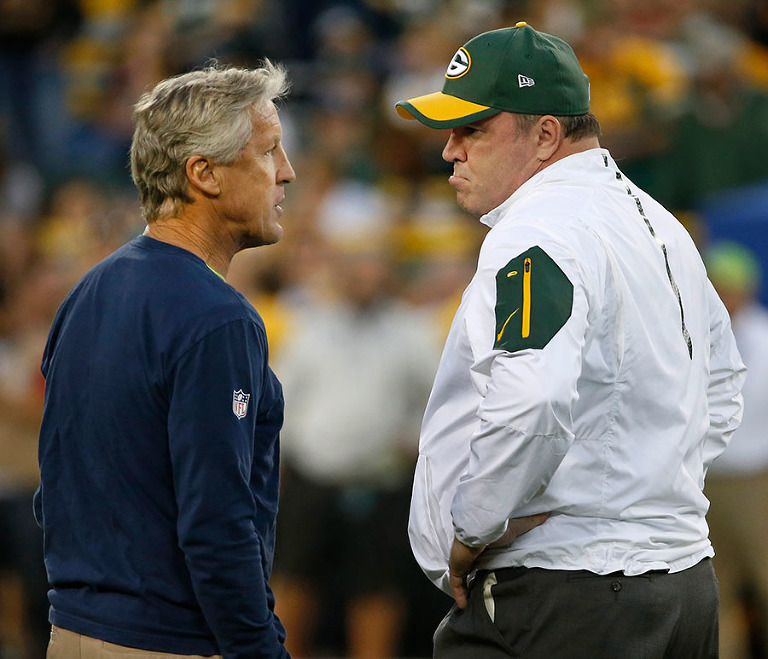 Seattle Seahawks head coach Pete Carroll talks with Green Bay Packers head coach Mike McCarthy before the game.
