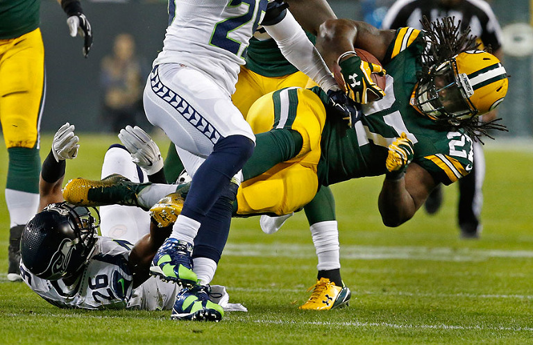 Green Bay Packers running back Eddie Lacy gets stopped by the Seattle Seahawks defense.