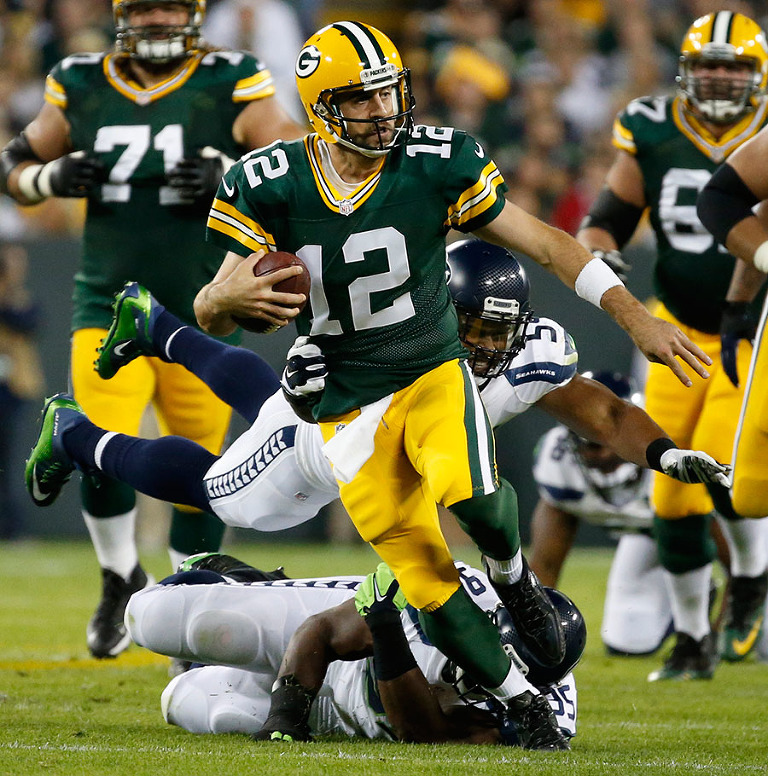 Green Bay Packers quarterback Aaron Rodgers runs for a first down.