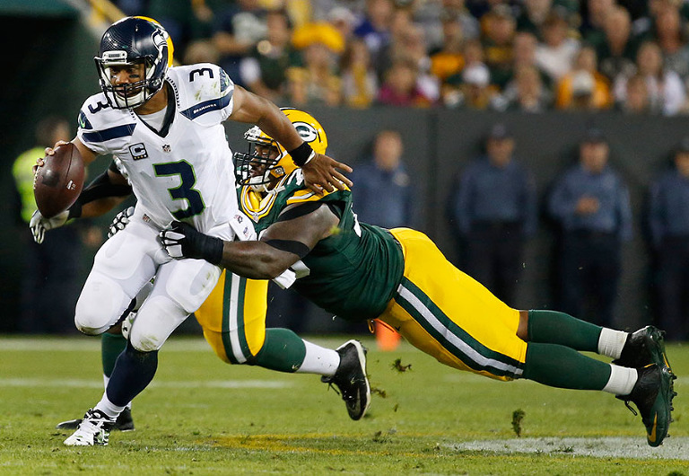Green Bay Packers defensive end Mike Daniels takes down Seattle Seahawks quarterback Russell Wilson.