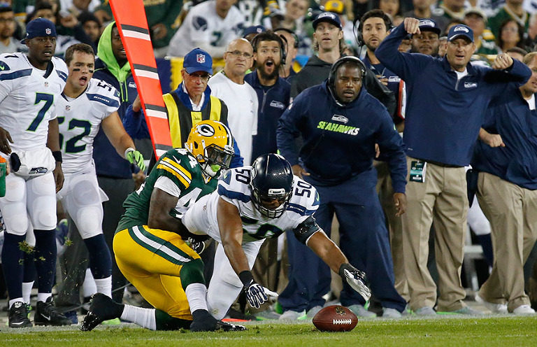 Seattle Seahawks outside linebacker K.J. Wright recovers a Green Bay Packers running back James Starks fumble