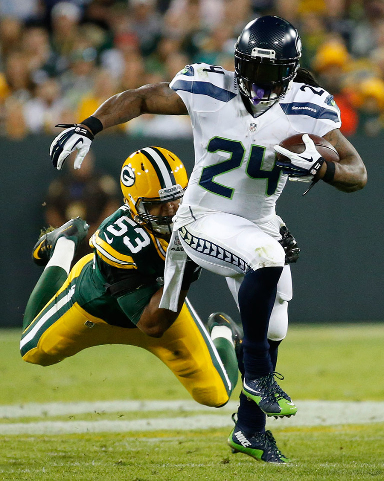 Green Bay Packers outside linebacker Nick Perry tries to defend Seattle Seahawks running back Marshawn Lynch.