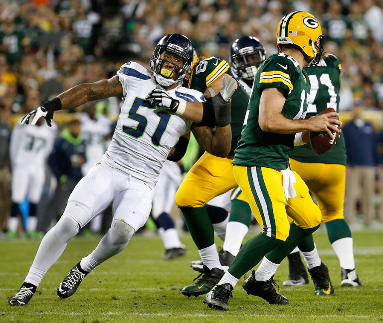 Seattle Seahawks outside linebacker Bruce Irvin pressures Green Bay Packers quarterback Aaron Rodgers.