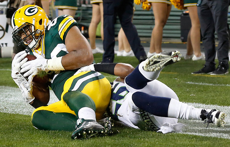 Green Bay Packers tight end Richard Rodgers scores as Seattle Seahawks cornerback Cary Williams defends.