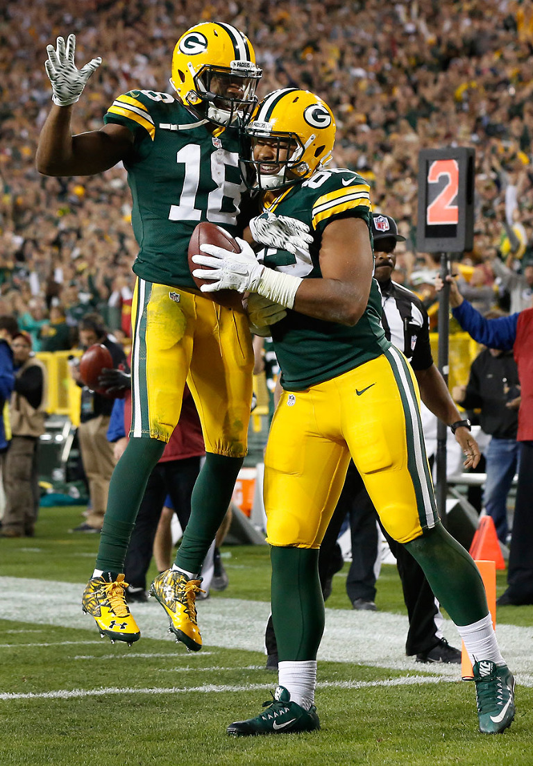 Green Bay Packers wide receiver Randall Cobb helps tight end Richard Rodgers celebrate touchdown.