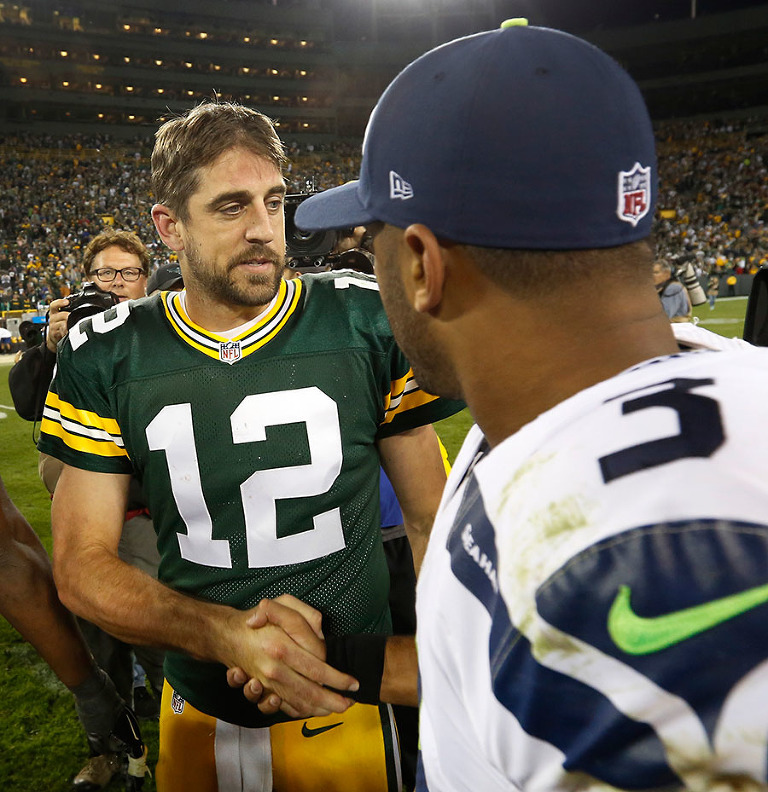 Green Bay Packers quarterback Aaron Rodgers and Seattle Seahawks quarterback Russell Wilson shake hands after the Packers defeated the Seahawks.