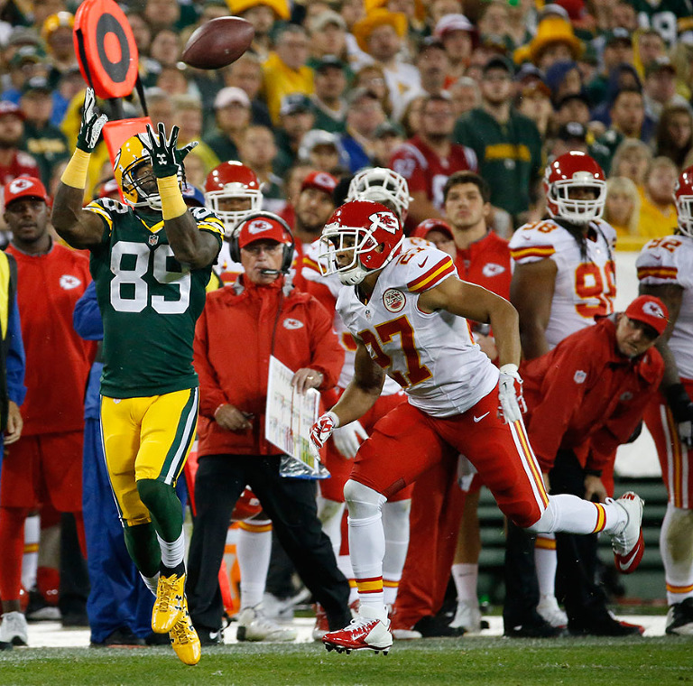 Green Bay Packers wide receiver James Jones pulls in a pass as Kansas City Chiefs defensive back Tyvon Branch defends.