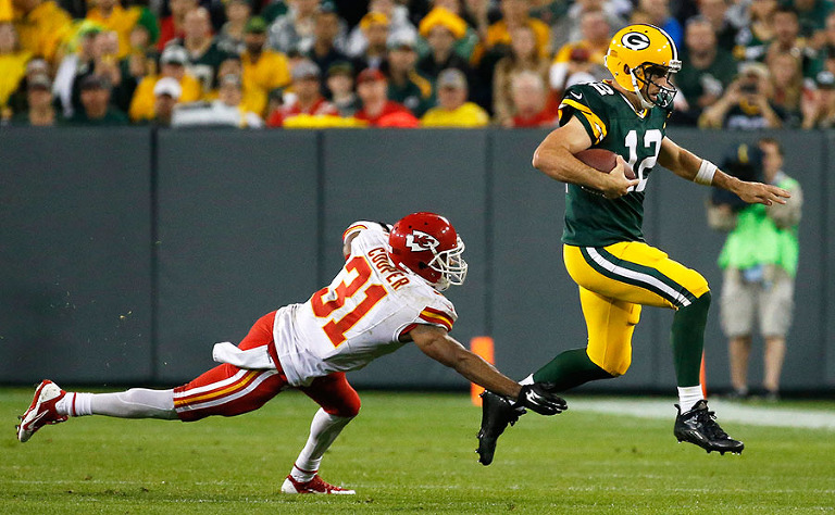 Green Bay Packers quarterback Aaron Rodgers tries to outrun the defense of Kansas City Chiefs cornerback Marcus Cooper.