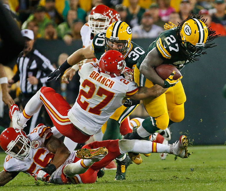 Kansas City Chiefs defensive back Tyvon Branch tries to take down Green Bay Packers running back Eddie Lacy.