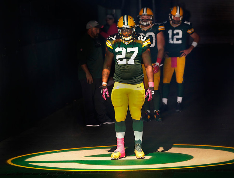 With John Kuhn and Aaron Rodgers waiting behind him Green Bay Packers running back Eddie Lacy gets ready to be introduced during player introductions.