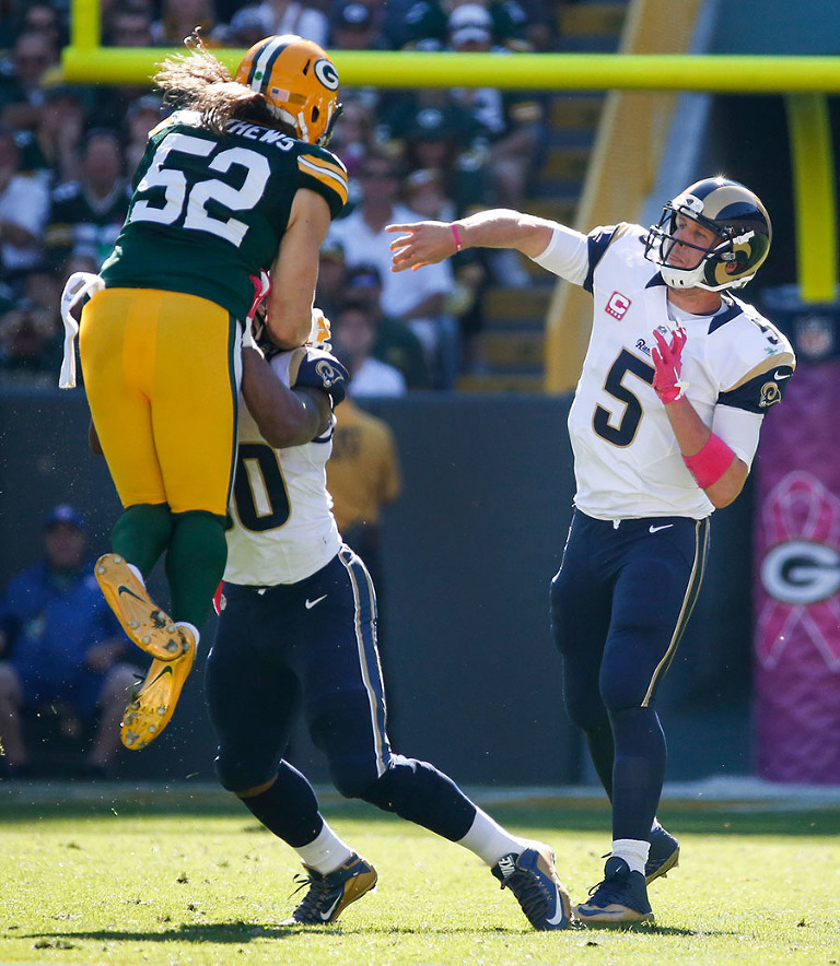 Green Bay Packers inside linebacker Clay Matthews tries to block a St. Louis Rams quarterback Nick Foles pass.