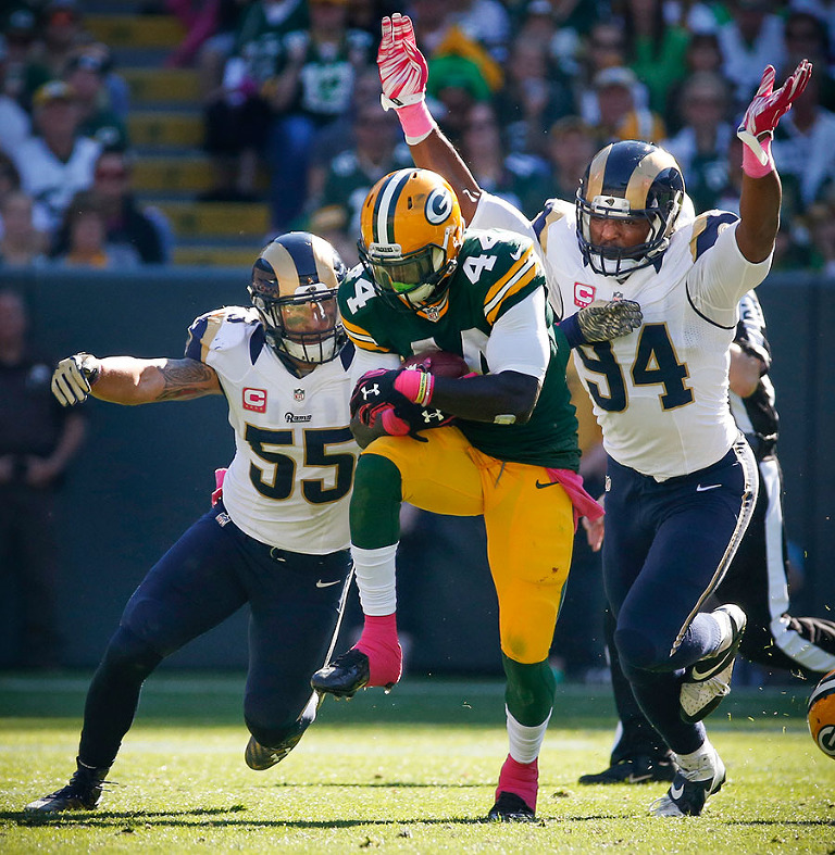 St. Louis Rams middle linebacker James Laurinaitis and defensive end Robert Quinn defend Green Bay Packers running back James Starks.