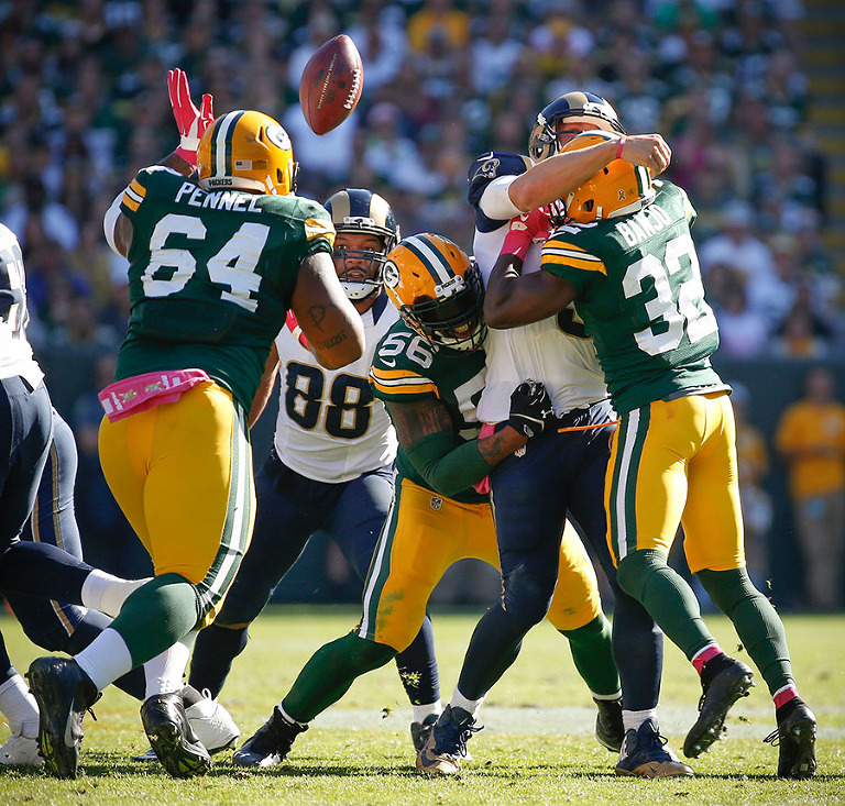 The Green Bay Packers defense knocks the ball out of St. Louis Rams quarterback Nick Foles hand.