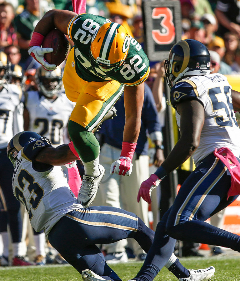 Green Bay Packers tight end Richard Rodgers jumps over the defense of St. Louis Rams free safety Rodney McLeod.