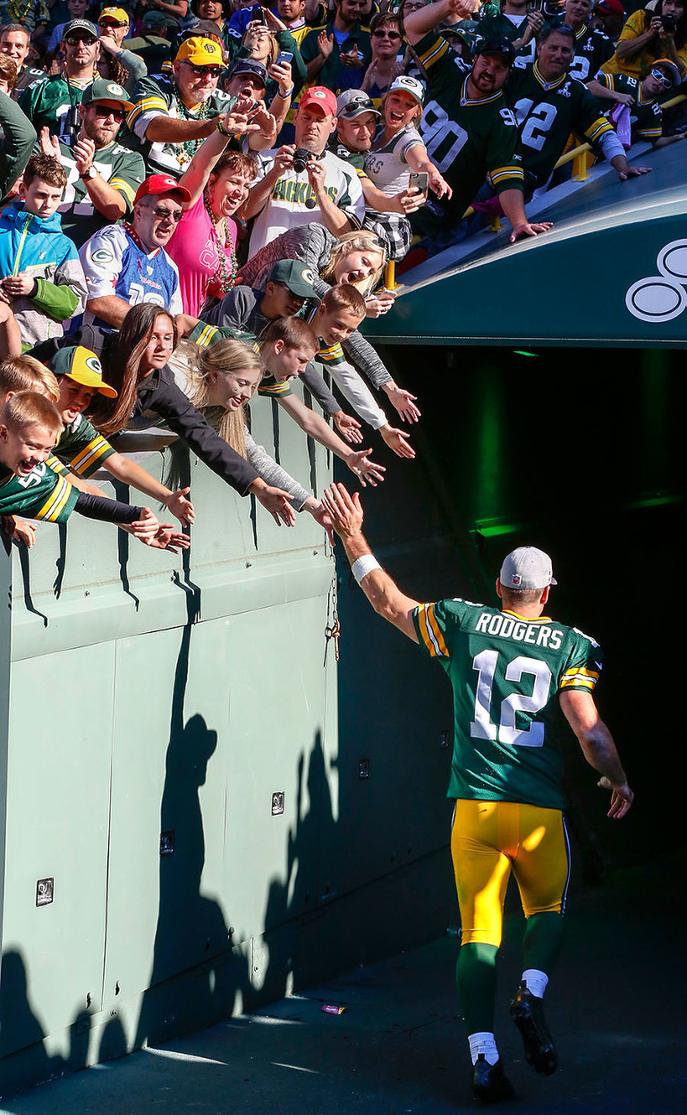 Green Bay Packers quarterback Aaron Rodgers runs off the field with a 5-0 record.