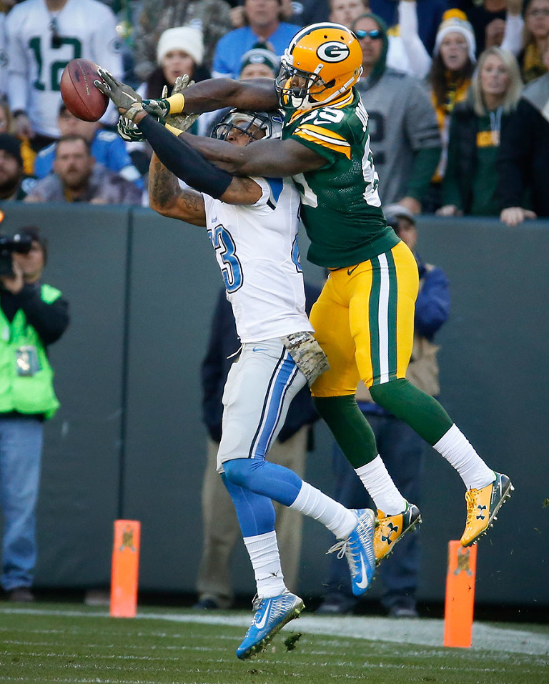 Detroit Lions cornerback Alex Carter breaks up a pass intended for Green Bay Packers wide receiver James Jones.