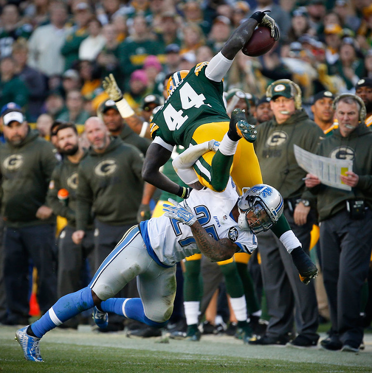 Detroit Lions free safety Glover Quin trips up Green Bay Packers running back James Starks.