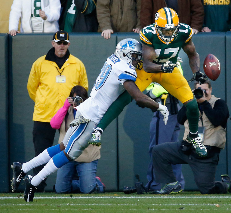 Detroit Lions' Crezdon Butler breaks up a two-point conversion intended for Green Bay Packers' Davante Adams.