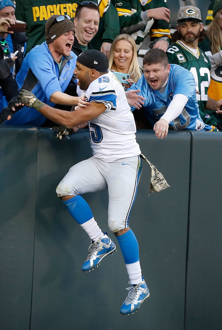Detroit Lions' Golden Tate celebrates with Lions fans after defeating the Packers.