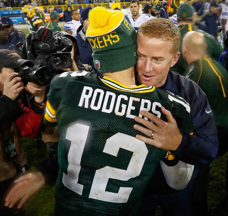Green Bay Packers quarterback Aaron Rodgers and Dallas Cowboys head coach Jason Garrett talk after the game.